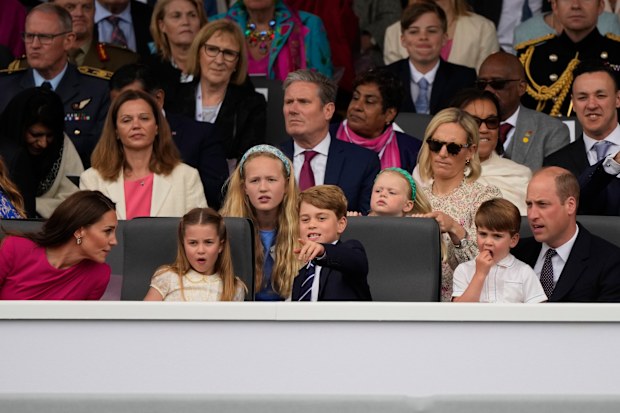 Prince William, right, and Kate, Duchess of Cambridge, left, attend with their children Prince George, center, Princess Charlotte, second left, and Prince Louis the Platinum Jubilee Pageant outside Buckingham Palace in London, Sunday, June 5, 2022, on the last of four days of celebrations to mark the Platinum Jubilee. 