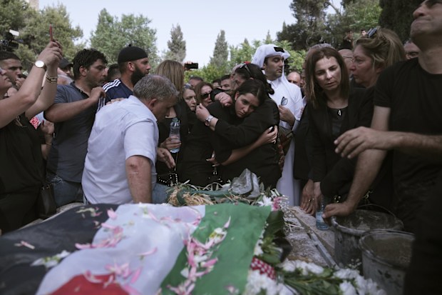 Mourners gather to bury slain Al Jazeera veteran journalist Shireen Abu Akleh in Jerusalem, Friday, May 13, 2022. Abu Akleh, a Palestinian-American reporter who covered the Mideast conflict for more than 25 years, was shot dead Wednesday during an Israeli military raid in the West Bank town of Jenin.(AP Photo/Mahmoud Illean)