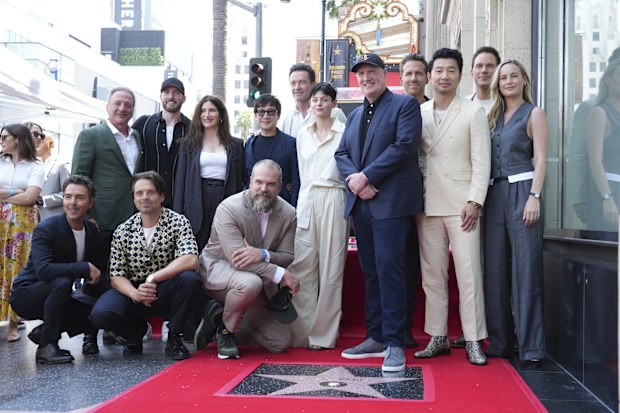 Shawn Levy, from left, Louis D'Esposito, Sebastian Stan, Chris Evans, Kathryn Hahn, David Harbour, Ke Huy Quan, Hugh Jackman, Emma Corrin, Kevin Feige, Ryan Reynolds, Simu Liu, Chris Pratt and Brie Larson attend a ceremony honoring Feige with a star on the Hollywood Walk of Walk of Fame