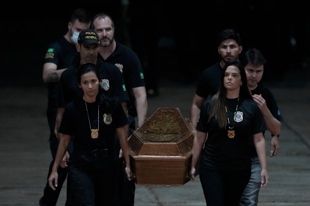 Federal police officers arrive with recovered human remains believed to be of the Indigenous expert Bruno Pereira of Brazil and freelance reporter Dom Phillips of Britain, at the Federal Police hangar in Brasília, Brazil, Thursday,, June 16, 2022. 