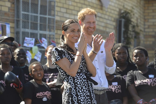 Meghan (left) and Prince Harry, (right), greet children and youths on a visit to the Nyanga Methodist Church in Cape Town, South Africa, Monday, Sept, 23, 2019 which houses a project where kids are taught about their rights, self-awareness and safety, and are provided self-defence classes and female empowerment training to young girls in the community.  