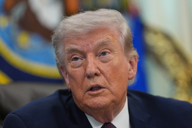 President Donald Trump answers questions from reporters after signing an executive order in the Oval Office of the White House Tuesday, March 31, 2026, in Washington. (AP Photo/Alex Brandon)