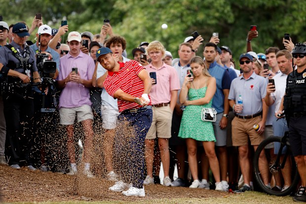 Xander Schauffele of the United States Team plays his third shot on the 17th hole as fans look on during Sunday singles matches on day four of the 2022 Presidents Cup at Quail Hollow Country Club on September 25, 2022 in Charlotte, North Carolina. (Photo by Jared C. Tilton/Getty Images)