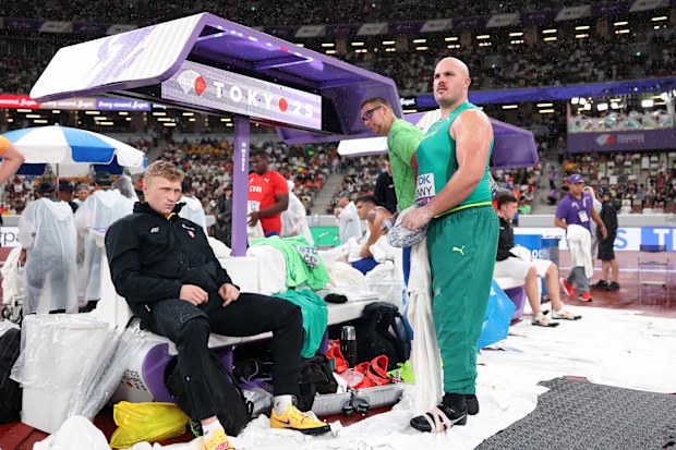 Martynas Alekna of Lithuania and Australia's Matt Denny pictured during the rain-drenched discus final.