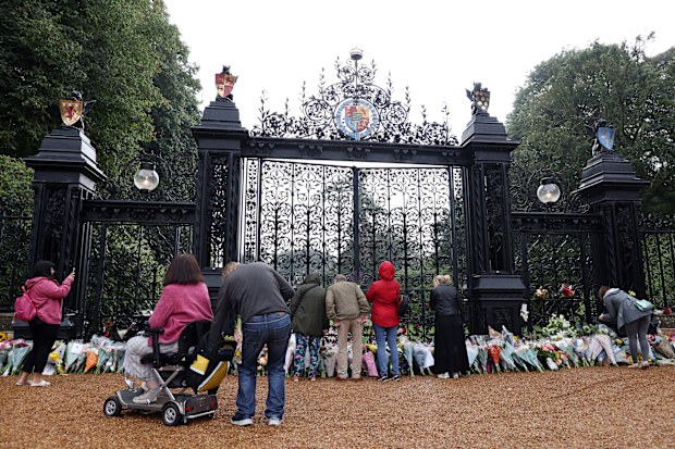 SANDRINGHAM, NORFOLK - SEPTEMBER 09: Members of the public lay floral tributes at The Norwich Gates at Sandringham House on September 09, 2022 in Sandringham, Norfolk. Elizabeth Alexandra Mary Windsor was born in Bruton Street, Mayfair, London on 21 April 1926. She married Prince Philip in 1947 and acceded the throne of the United Kingdom and Commonwealth on 6 February 1952 after the death of her Father, King George VI. Queen Elizabeth II died at Balmoral Castle in Scotland on September 8, 2022,