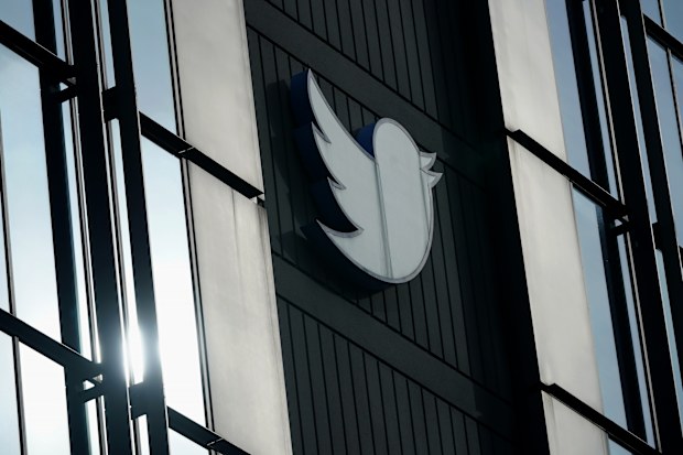 A Twitter logo hangs outside the company's offices in San Francisco, Monday, Dec. 19, 2022. (AP Photo/Jeff Chiu)