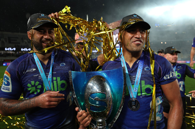 Akira Ioane (left) and Rieko Ioane (right) of the Blues celebrate with the trophy during the Super Rugby Pacific final match at Eden Park.