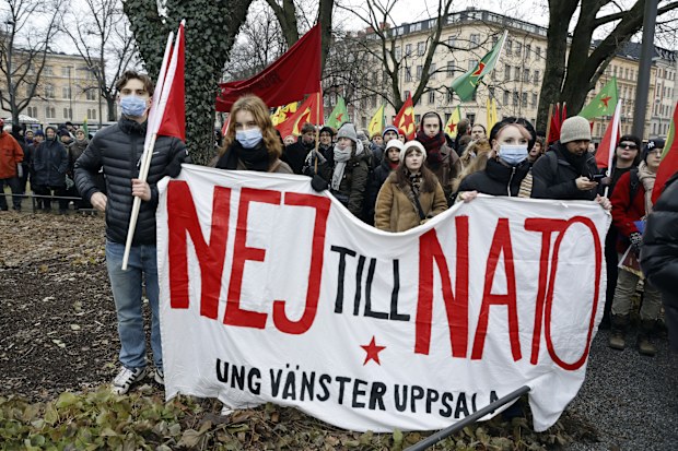 People take part in a demonstration against Turkish President Recep Tayyip Erdogan and Sweden's NATO bid arranged by The Kurdish Democratic Society Center in Sweden, in Stockholm, Saturday, Jan. 21. 2023. Sign reads in Swedish "No to NATO". Turkey has blocked Sweden and Finlands bids to join NATO, which needs approval by all member states, saying Sweden in particular needs to crack down on Kurdish and other groups that Ankara considers as terrorists. (Christine Olsson/TT via AP)