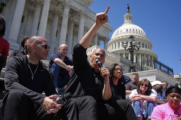 House Minority Leader Hakeem Jeffries, D-N.Y., from front left, Sen. Cory Booker D-N.J.,  Rep. Marilyn Strickland, D-Va., and Rep. Greg Landsman, D-Ohio, in background second left, participate in a live-streamed conversation on the steps of the Capitol, Sunday, April 27, 2025, in Washington. (AP Photo/Manuel Balce Ceneta)