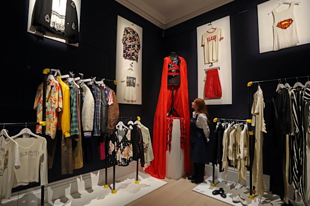 A Sotheby's handler examines costumes and clothes on display, during Sotheby's 'Freddie Mercury: A World of His Own' press preview in London, Britain August 3, 2023. 