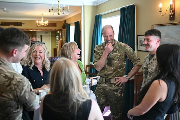 BULFORD, WILTSHIRE - MARCH 26: Prince William, Prince of Wales as Colonel-in-Chief of the Regiment listens to a joke as he meets with soldiers of the 1st Battalion Mercian Regiment and family members following their six-month deployment to Estonia, on March 26, 2026 in Bulford, Wiltshire, England  (Photo by Justin Tallis-WPA Pool/Getty Images)