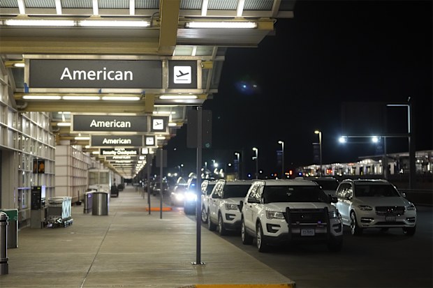 Law enforcement vehicles are parked at Ronald Reagan Washington National Airport, Wednesday, Jan. 29, 2025, in Arlington, Va. (AP Photo/Julio Cortez)
