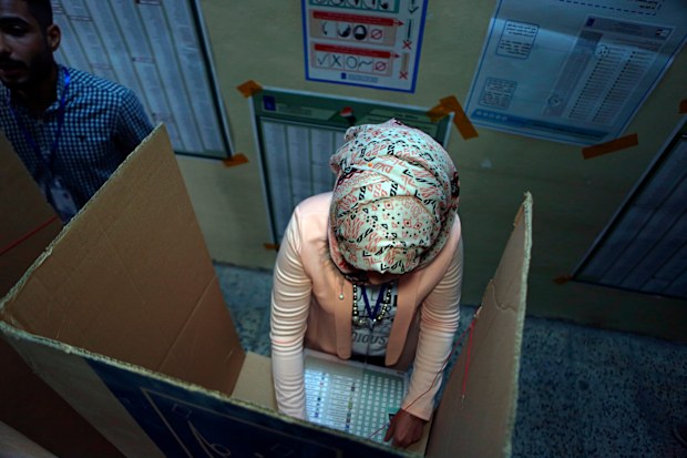 An Iraqi woman casts her vote in the country's parliamentary elections in Baghdad, Iraq, Saturday, May 12, 2018. Polls opened across Iraq on Saturday in the first national election since the declaration of victory over the Islamic State group. (AP Photo/Khalid Mohammed
