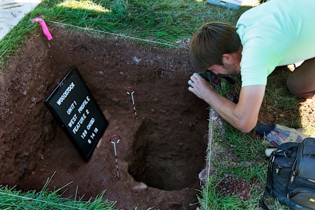  Josh Anderson, of the Public Archaeology Facility at Binghamton University, photographs an excavation at the site of the original Woodstock Music and Art Fair, in Bethel, N.Y. Information from the dig will help a museum plan interpretive walking routes in time for the concertâs 50th anniversary next year. (AP Photo/Richard Drew) 