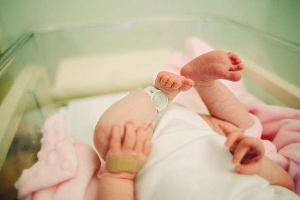Baby in hospital with tag on leg