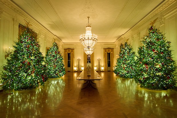 Christmas trees decorate the East Room of the White House during a press preview of the Christmas decorations "Home is Where the Heart Is," Monday, Dec. 1, 2025, in Washington.