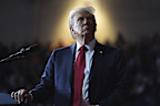 President Donald Trump watches a video screen at a campaign rally.