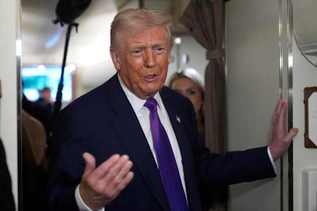 President Donald Trump speaks to reporters aboard Air Force One shortly before takeoff, Thursday, Feb. 19, 2026, at Joint Base Andrews, Md.