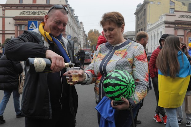 Ukrainians gather in downtown to celebrate the recapturing of Kherson city, Ukraine, Odesa, Saturday, Nov. 12, 2022. 