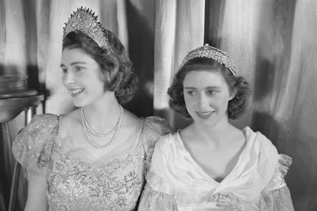 Princess Elizabeth (Queen Elizabeth II) and Princess Margaret (1930-2002), both dressed in elaborate gowns, pictured during a royal pantomime production of 'Old Mother Red Riding Boots' at Windsor Castle, Berkshire, Great Britain, 22 December 1944. (Photo by Lisa Sheridan/Studio Lisa/Getty Images)