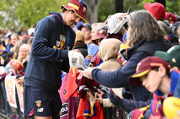 Joe Daniher of the Lions signs autographs the day after the grand final in Melbourne.