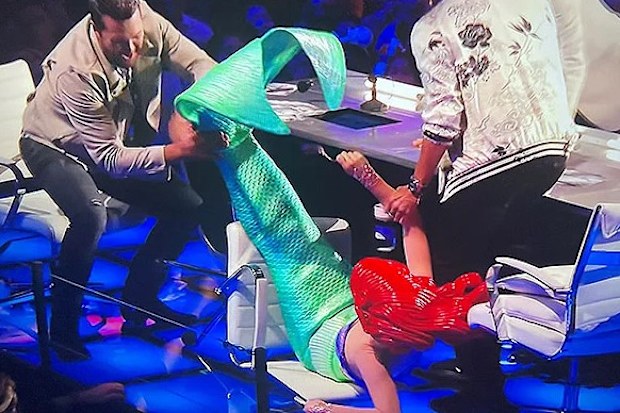 Katy Perry falls off her chair while dressed as the Little Mermaid on American Idol 