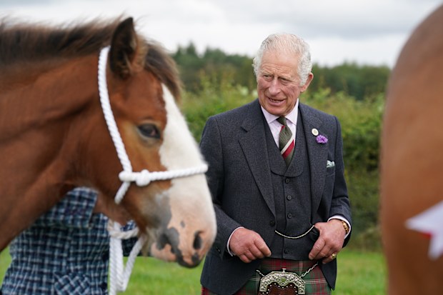 LANARK, SCOTLAND - SEPTEMBER 07: Prince Charles, Prince of Wales, known as the Duke of Rothesay while in Scotland, and Patron of the Clydesdale Horse Society, reacts after viewing a statue of a Clydesdale horse situated by Lanark Auction Market, Lanark Agricultural Centre on September 7, 2022 in Lanark, Scotland. The Duke and Duchess of Rothesay visit Lanarkshire and the Scottish borders. (Photo by Andrew Milligan - WPA Pool/Getty Images)