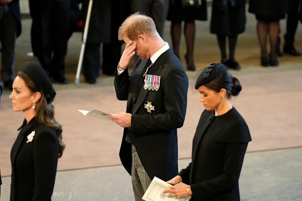 Catherine, Princess of Wales, Prince Harry, Duke of Sussex and Meghan, Duchess of Sussex pay their respects in The Palace of Westminster after the procession for the Lying-in State of Queen Elizabeth II on September 14, 2022 in London, England. 