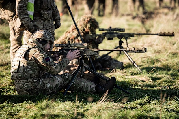 WILTSHIRE, ENGLAND - NOVEMBER 26: Prince William, Prince of Wales, Colonel of the Welsh Guards, firing a sniper rifle, during a visit to the 1st Battalion Welsh Guards to hear how they have been transitioning from ceremonial duty back to the Field Army at Salisbury Plain on November 26, 2024 in Wiltshire, England. (Photo by Aaron Chown - WPA Pool/Getty Images)