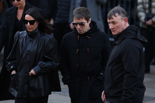 MANCHESTER, ENGLAND - DECEMBER 22:   Liam Gallagher & Debbie Gwyther attend the funeral of Gary Mounfield, also known as Mani, at Manchester Cathedral on December 22, 2025 in Manchester, England. Mani is know for being the bass guitarist in rock bands The Stone Roses and Primal Scream. He died on November 20, 2025 at the age of 63 after suffering from a long-standing lung condition.  (Photo by Ryan Jenkinson/Getty Images)