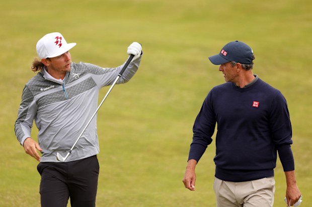 Cameron Smith of Australia talks with Adam Scott of Australia during a practice round prior to The 152nd Open championship at Royal Troon on July 16, 2024 in Troon, Scotland. (Photo by Andrew Redington/Getty Images)