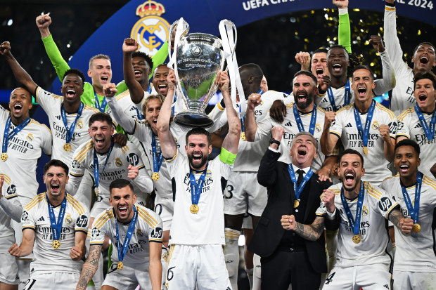 Nacho of Real Madrid lifts the Champions League trophy after his team's victory.