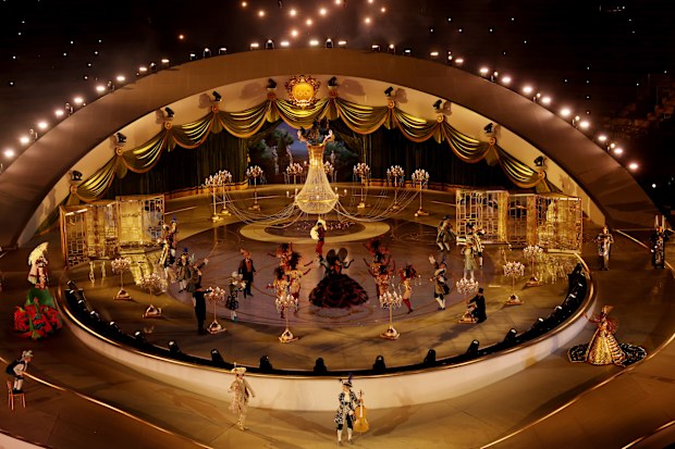 A general view of an illuminated chandelier as performers dance during the Milano Cortina closing ceremony.