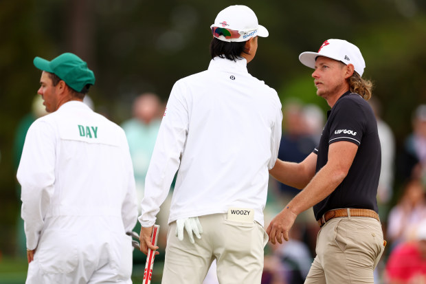 Min Woo Lee and Cameron Smith of Australia speak during a practice round prior to the 2024 Masters Tournament.