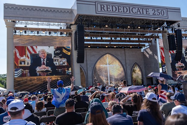 A person worships as a recorded video message from President Donald Trump plays at Rededicate 250, a mostly conservative Christian prayer gathering in honor of the United States' 250th anniversary, on the National Mall, Sunday, May 17, 2026, in Washington. (AP Photo/Julia Demaree Nikhinson)