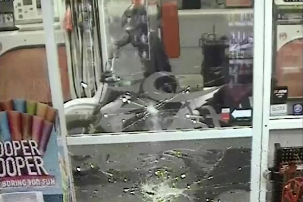 Police allege the two suspects smashed the service station window before attacking the worker with a hammer.