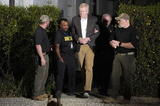 Alex Murdaugh , centre, is led out of Colleton County Courthouse by sheriff's deputies after being convicted Thursday, March 2, 2023, in Walterboro, S.C
