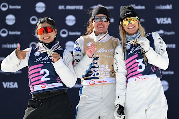 From left: Gold medallist Kaila Kuhn of the USA, silver medallist Mengtao Xu of China, and bronze medallist Danielle Scott of Australia celebrate landing on the podium at the 2025 aerial skiing world championships.
