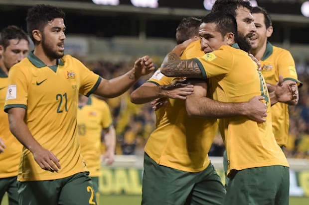 Socceroos captain Mile Jedinak (centre) celebrates with Tim Cahill after scoring against Kyrgyzstan. (AAP)