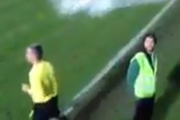 A linesman, moments before getting drenched by fans. (Supplied)