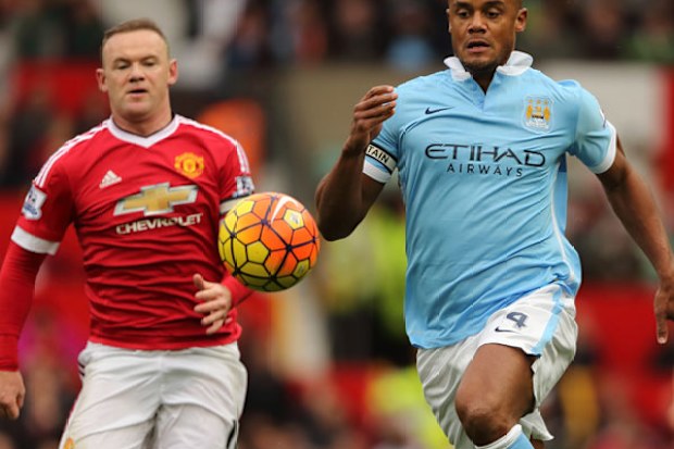 City's Vincent Kompany (R) leads Wayne Rooney to the ball. (Getty)