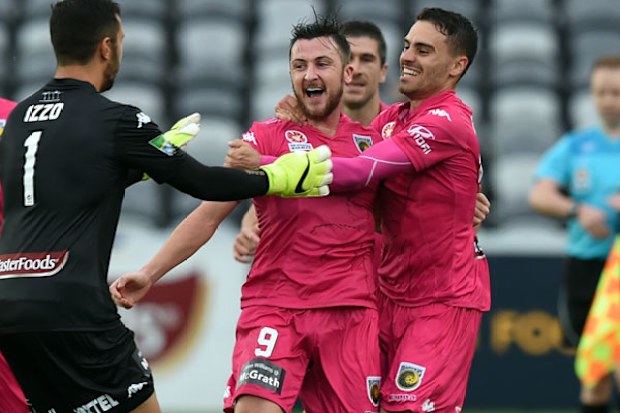 The Mariners rush to celebrate with goal hero Roy O'Donovan. (AAP)