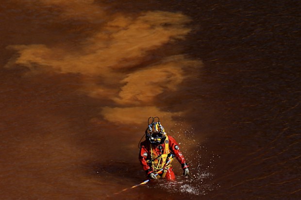 A diver walks out from a toxic man-made lake after a dive search for a third victim near the village of Mitsero outside of the capital Nicosia, Cyprus. Army captain Nicholas Metaxas was sentenced to seven life terms after he pleaded guilty to the premeditated murder and kidnapping of seven foreign women and girls. 
