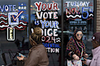 Chelsea Salama, right, hands out fliers while volunteering with the Abandon Harris movement encouraging voters to choose Green Party presidential candidate Jill Stein, Monday, Nov. 4, 2024, in Dearborn, Mich. (AP Photo/David Goldman)