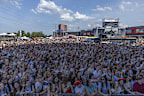People enjoy a concert at the Atlas Festival in Kyiv, Ukraine, Sunday, July 21, 2024. This year, Ukraine's largest music festival struck a different chord. Gone were the international headliners, the massive performance halls and the hundreds of thousands of visitors. (AP Photo/Anton Shtuka)