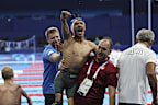Turkey's Umut Unlu, carried by Mehmet Ali Albas, celebrates winning the men's 50 freestyle S3, at the Paris La Défense Arena, during the 2024 Paris Paralympics, Friday, Sept. 6, 2024, in Paris, France. 