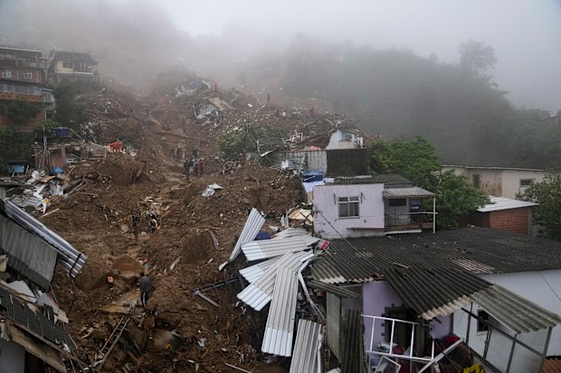 Rescue workers and residents look for victims  in an area affected by landslides in Petropolis, Brazil, Wednesday, Feb. 16, 2022.