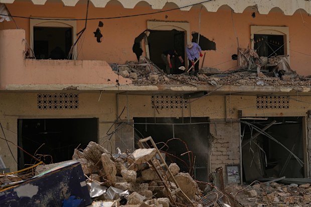 Residents remove rubble from their destroyed house on the second day of a ceasefire between Hezbollah and Israel in Jibchit village, south Lebanon.