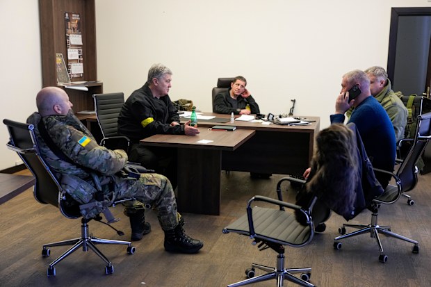 Former Ukrainian President Petro Poroshenko, second left, attends a meeting in the City Hall in Kyiv, Ukraine, Sunday, Feb. 27, 2022.