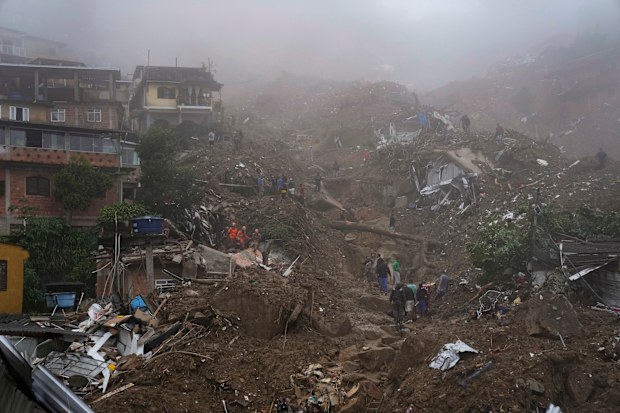 Rescue workers and residents look for victims  in an area affected by landslides in Petropolis, Brazil, Wednesday, Feb. 16, 2022. 